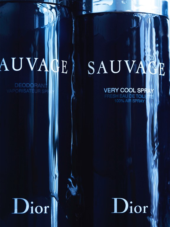 Two cans of Dior Sauvage men's fragrance are presented in a close-up shot, featuring a sleek design with product details and the Dior logo.