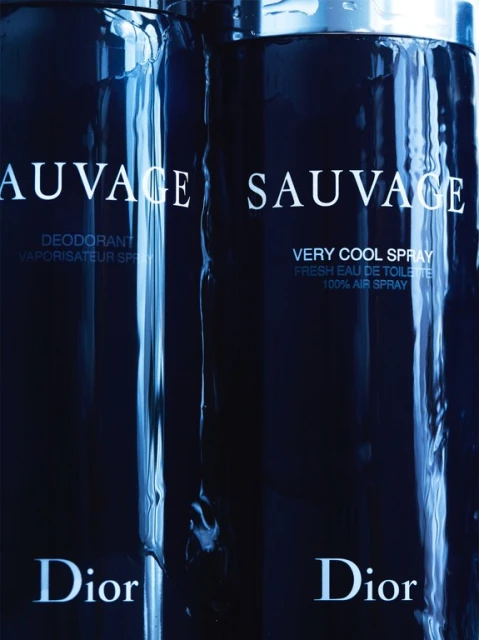 Two cans of Dior Sauvage men's fragrance are presented in a close-up shot, featuring a sleek design with product details and the Dior logo.