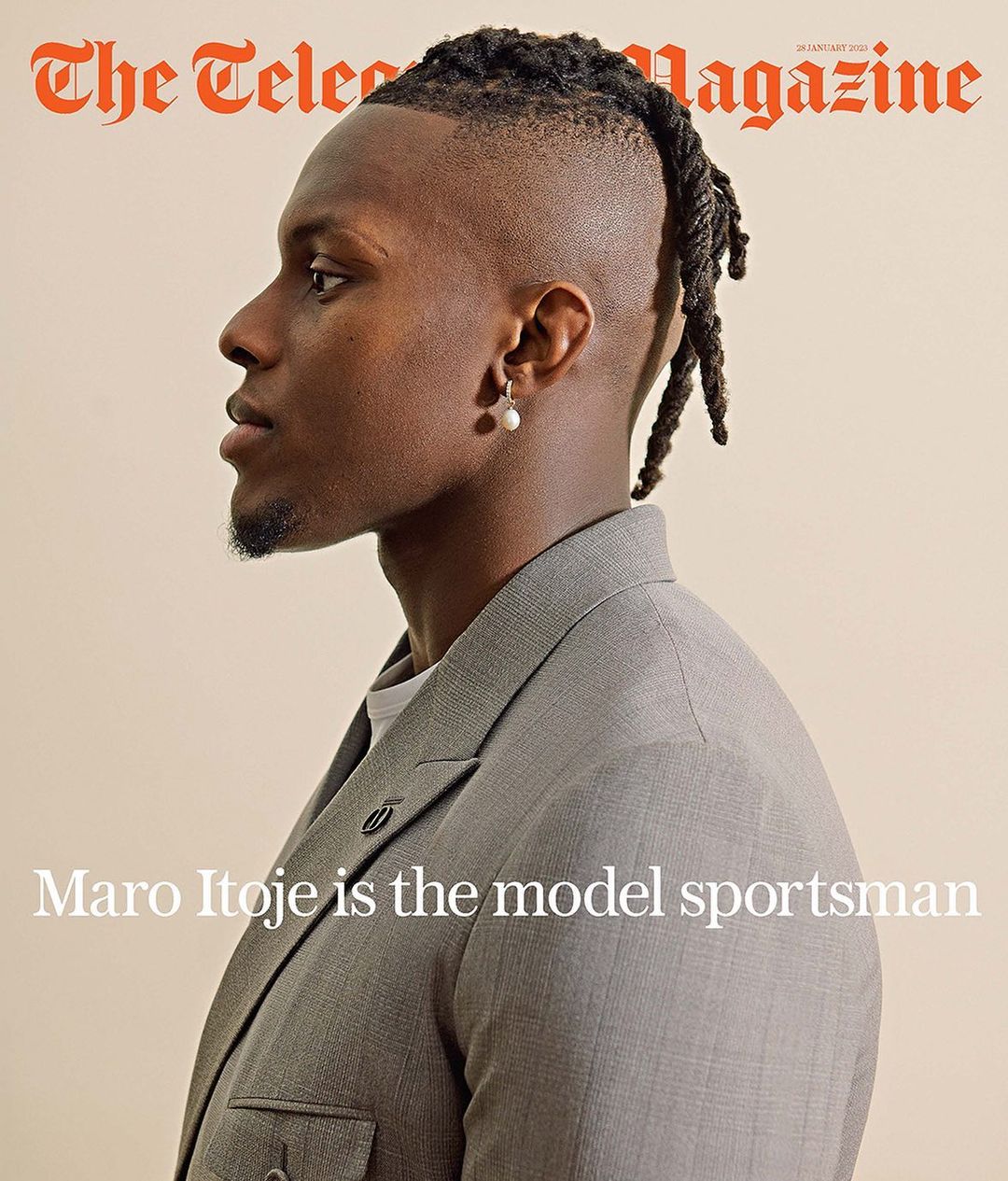 Profile portrait of Maro Itoje wearing a gray suit jacket, facing left, with his hair in dreadlocks and a cream-colored background.