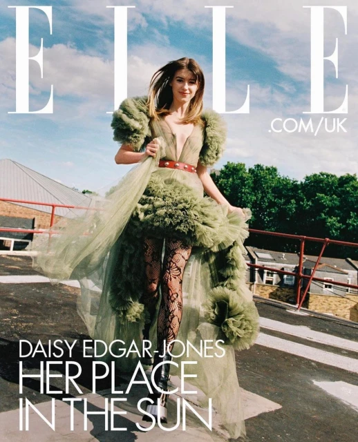 Elle Magazine cover featuring Daisy Edgar-Jones in an olive green tulle dress on a rooftop against a sky with clouds and buildings.