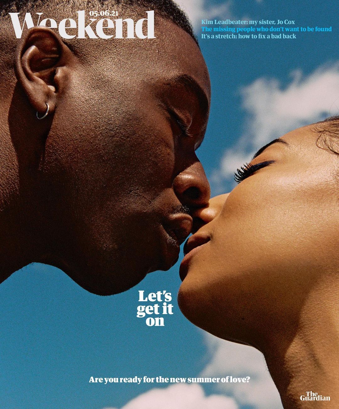 An interracial couple is seen close-up in a romantic pose against a blue sky in a magazine cover image, evoking feelings of affection and love.
