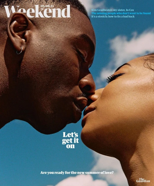 An interracial couple is seen close-up in a romantic pose against a blue sky in a magazine cover image, evoking feelings of affection and love.