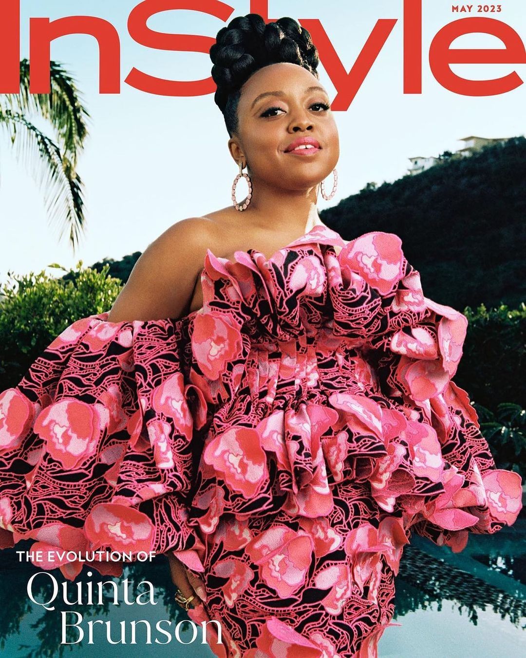 Magazine cover featuring Quinta Brunson in a pink floral dress, large hoop earrings, and an updo, set against an outdoor leafy background.