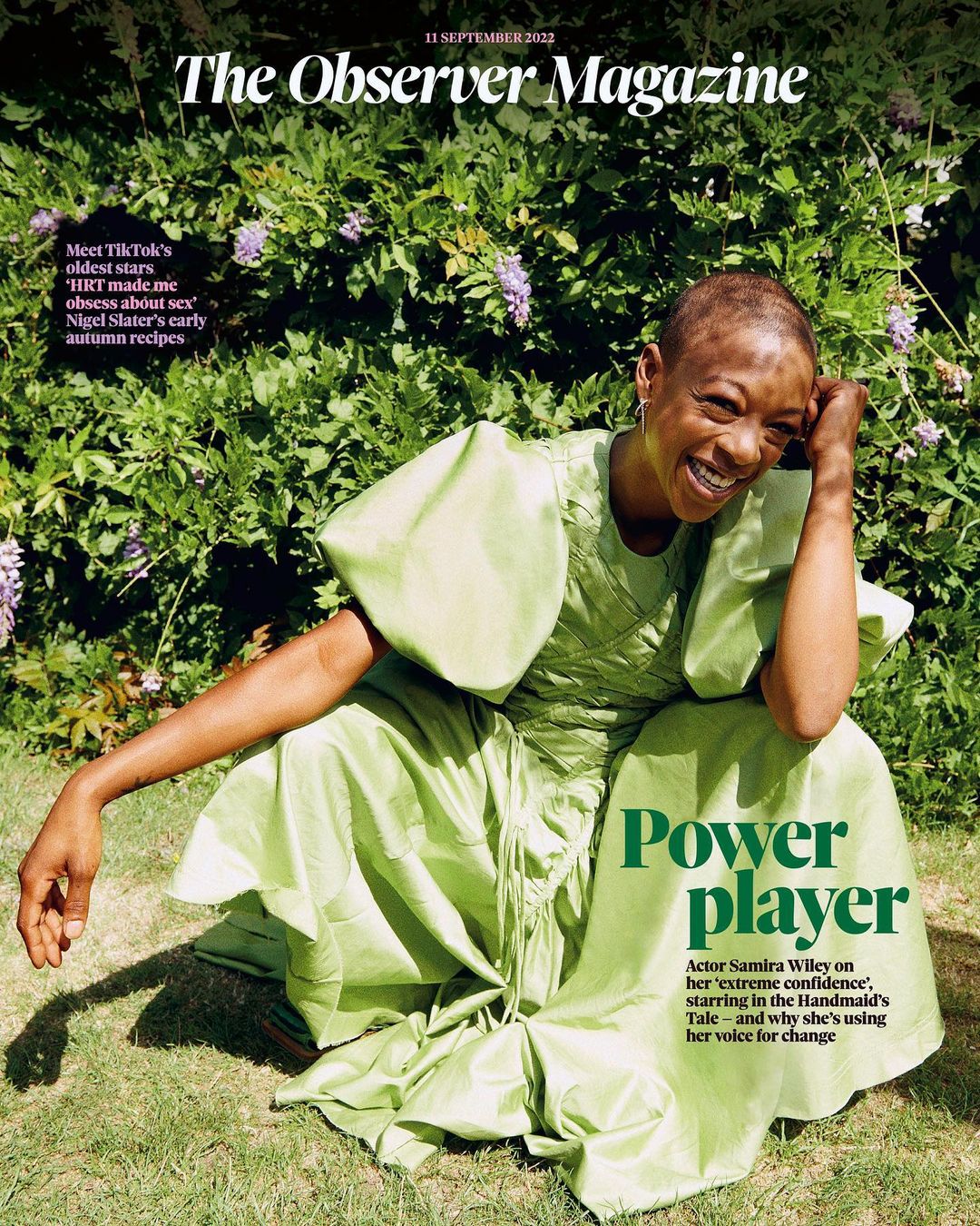 Magazine cover featuring Samira Wiley in a green dress, photographed outdoors against a backdrop of green foliage and flowering vines.