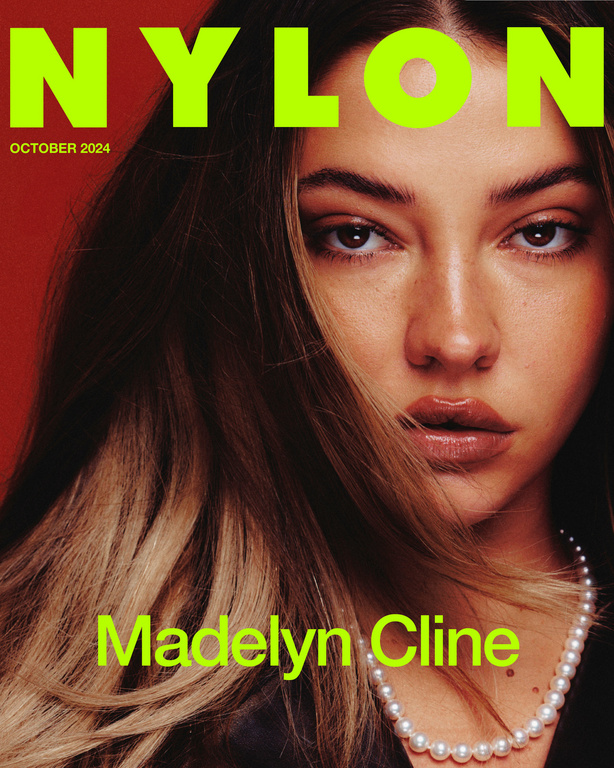 Close-up cover shot of Madelyn Cline on Nylon magazine, October 2024 issue. The actress wears a pearl necklace and poses on red background.