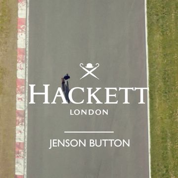 Overhead shot on a racetrack features a male figure on a bicycle, branded Hackett London logo and Jenson Button text.