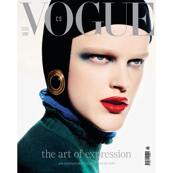 Vogue cover featuring a model with bold makeup, wearing a dark cap and green top with blue ruffled collar, with focus on her face.
