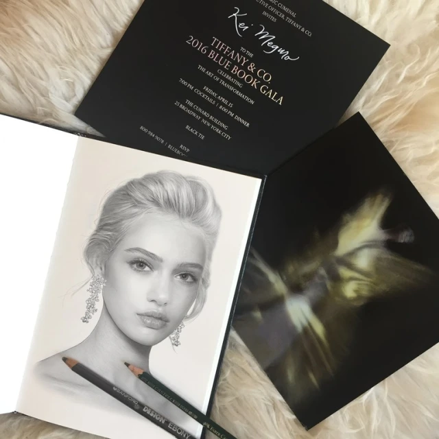 Drawing of a fair-skinned woman with chandelier earrings in a sketchbook with TIFFANY & CO. invitation and art photography.
