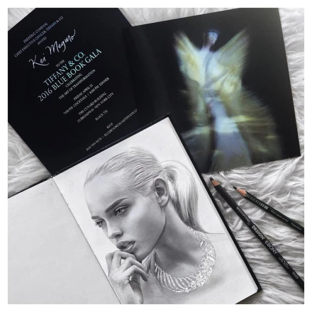 Pencil drawing of a woman with jewelry, Tiffany & Co. gala invitation, and pencils arranged on a white fur-like surface.