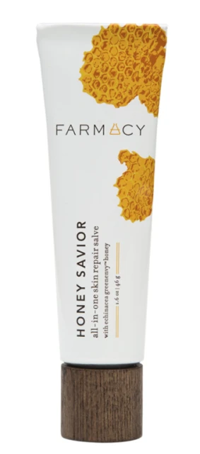 Farmacy Honey Savior skin repair salve in white tube with a wooden cap. It has honey-themed decorations and product-related text.