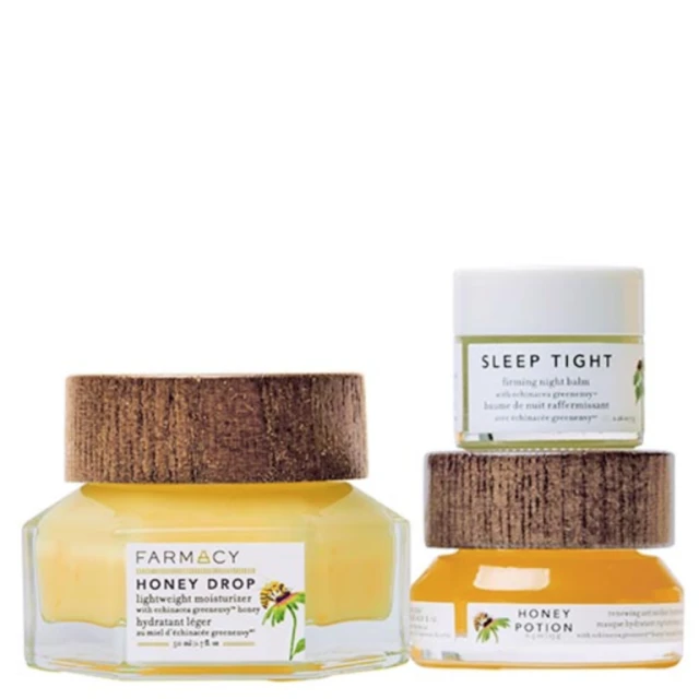 Farmacy skincare set with Honey Drop moisturizer, Sleep Tight balm, and Honey Potion mask. Product photography featuring clear glass and wood lids.