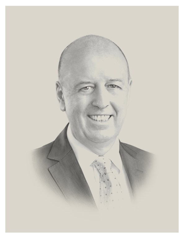 Portrait of a smiling, bald adult man in a suit and tie against a neutral background. The portrait is rendered in a monochrome style.