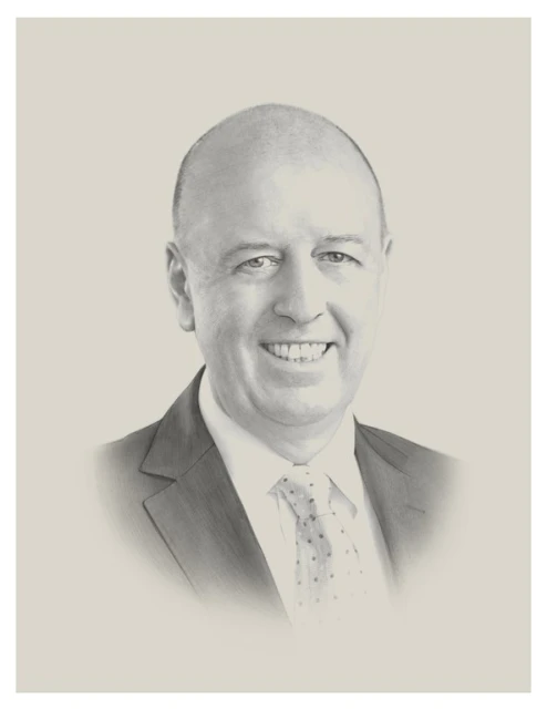 Portrait of a smiling, bald adult man in a suit and tie against a neutral background. The portrait is rendered in a monochrome style.