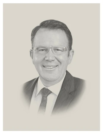 Pencil art portrait of an adult man wearing glasses, a suit, and a tie against a neutral background with a vignette effect.