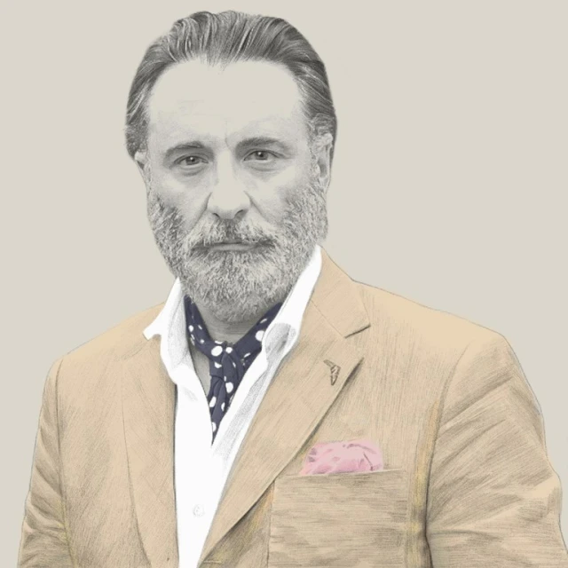 Illustration of mature man in suit jacket, polka dot ascot, and pocket square, grey beard, and silver hair, looking at the camera.