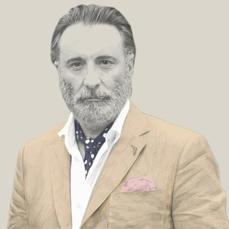 Illustration of mature man in suit jacket, polka dot ascot, and pocket square, grey beard, and silver hair, looking at the camera.