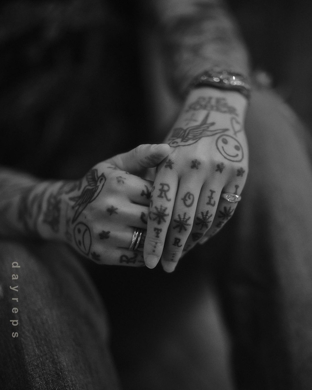 Close-up monochrome portrait of tattooed hands clasped together, photographed by Allie and Jesse.