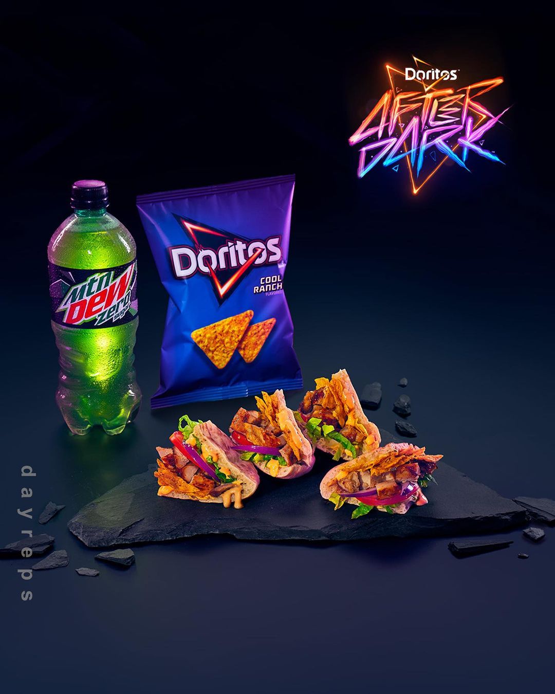 Chips and tacos served with Mountain Dew on a slate platter against a dark backdrop with neon brand logo.
