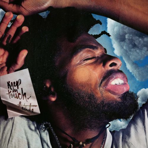 Artistic portrait of an African American man with closed eyes, beard, and an outstretched hand, against a sky-like backdrop.