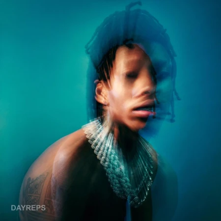 Portrait of a Black man with dreadlocks wearing a ruffled necklace against a teal background captured with multiple exposure technique.