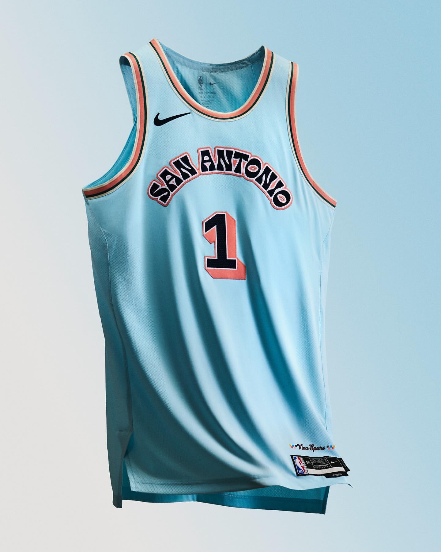 San Antonio Spurs #1 jersey displayed on light blue background. Basketball apparel with team logo and number on the front.