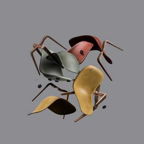 Collection of mid-century modern molded plastic shell chairs with wood legs in red, yellow, and green arranged in a levitating heap.