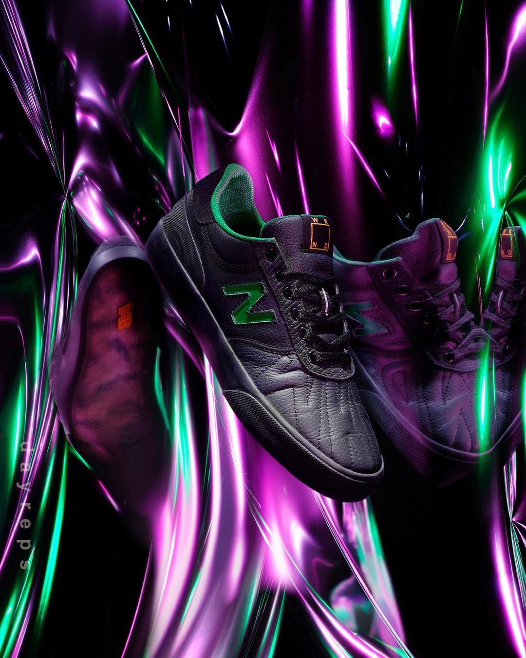 Black New Balance Numeric skateboarding shoes with green accents set against an abstract neon green and purple background.