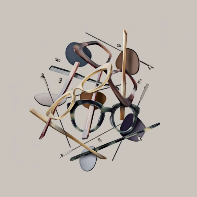 Still life arrangement featuring a variety of eyeglasses and eyeglass components in a seemingly levitating composition.