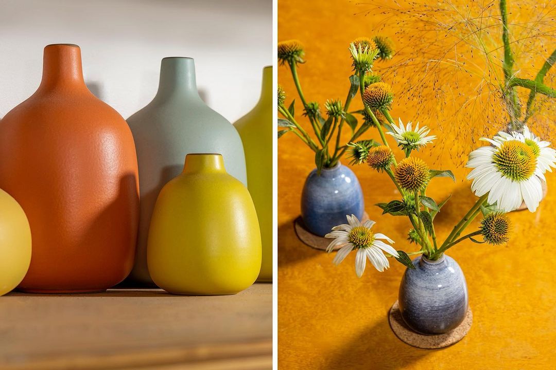 Still life of colorful ceramic vases and floral arrangements in natural light against yellow and white background. Interior design.