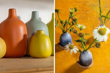 Ceramic vases in terracotta, sage green, and yellow displayed alongside blue vases holding white coneflowers.