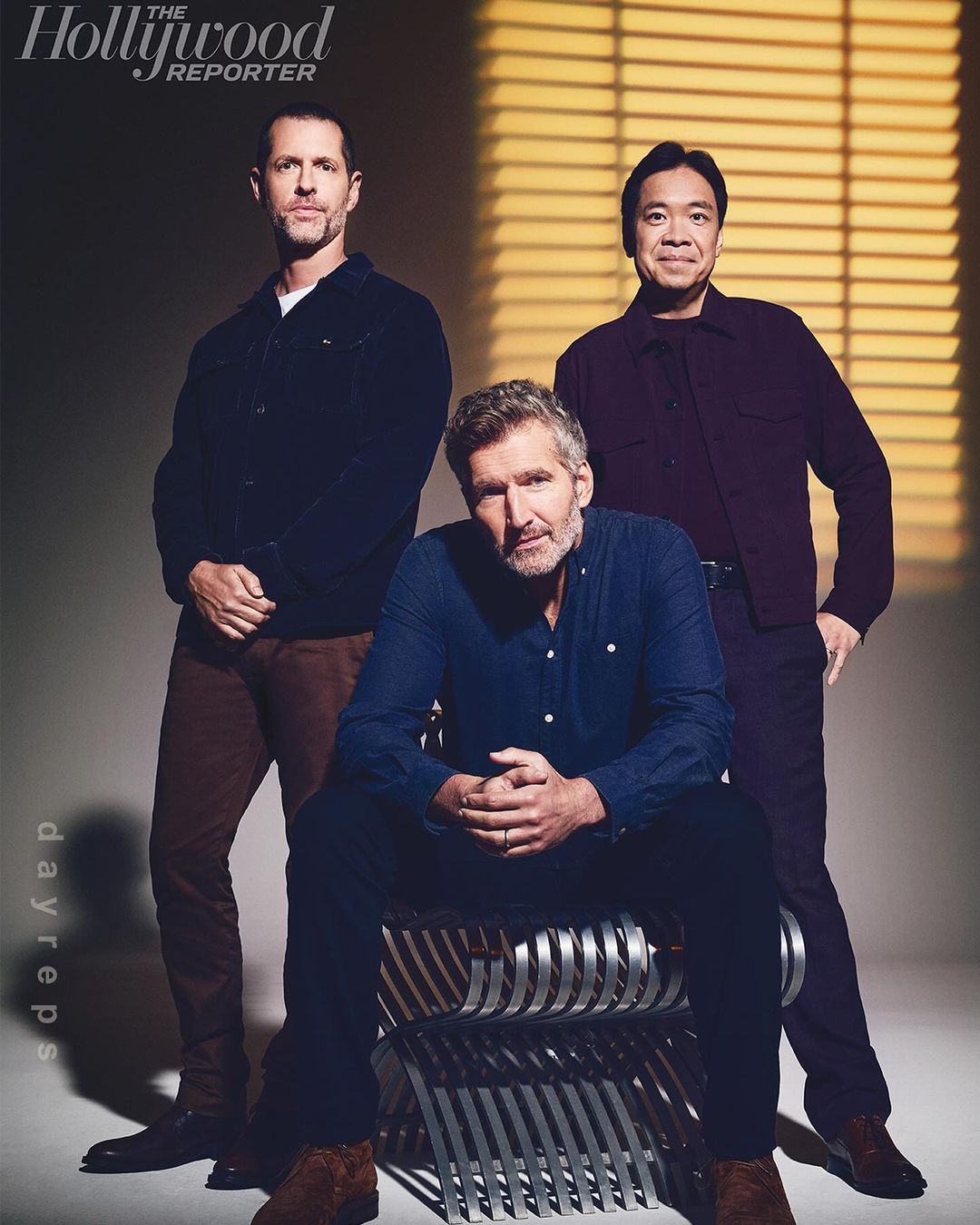 Three men posing indoors for a cover photo from The Hollywood Reporter, featuring neutral lighting, and a modern metal chair.