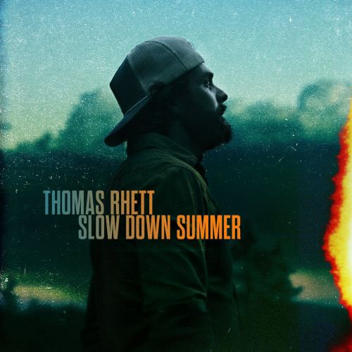 Thomas Rhett album cover featuring a bearded man wearing a baseball cap in an outdoor setting at daytime with a green and blue color palette.