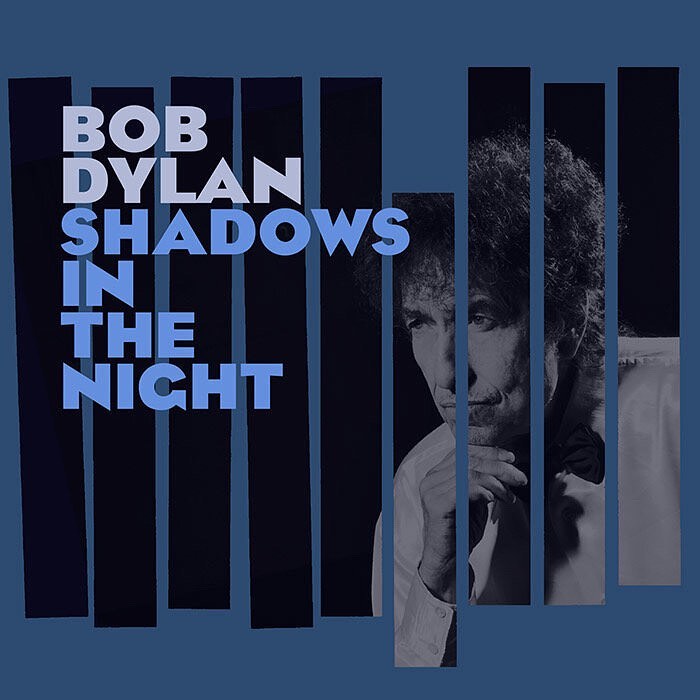 Bob Dylan album cover, 'Shadows in the Night,' features portrait and geometric design with a blue color scheme, reflecting a classic, vintage aesthetic.