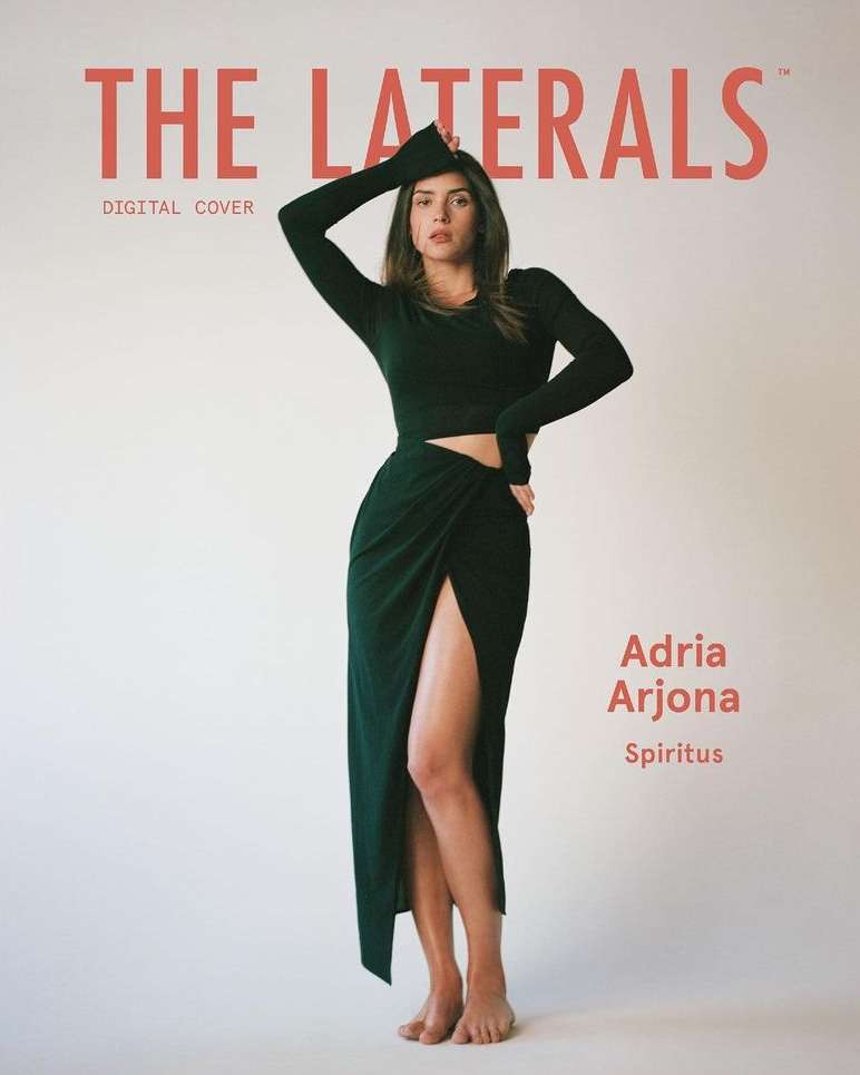 Magazine cover featuring a model in a long-sleeved green top and matching long skirt with a slit, posing in front of a white backdrop.