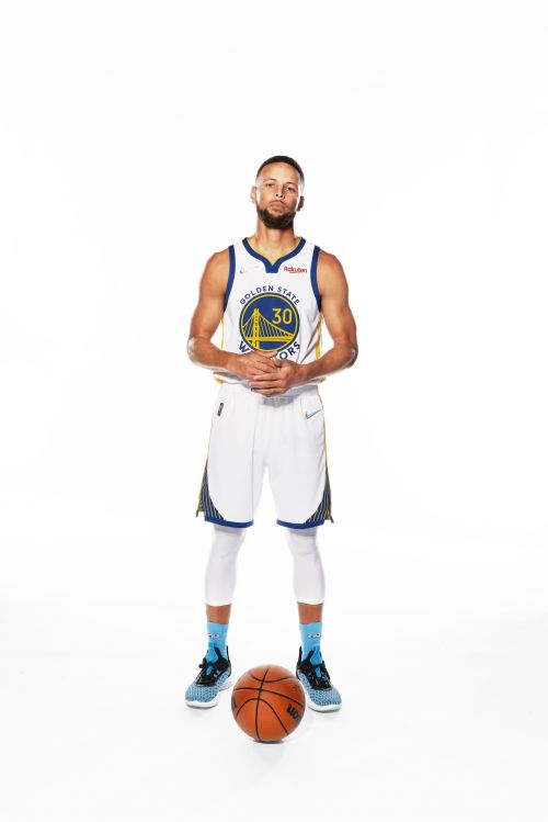Full shot of an adult male basketball player in uniform with a basketball on a white background, wearing a blue and gold jersey.