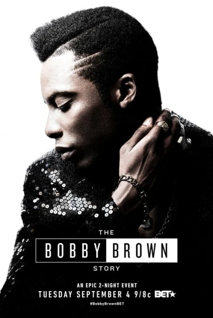 Profile of adult male on promotional poster for The Bobby Brown Story on BET; wearing sequined jacket, rings, bracelet. White backdrop. 