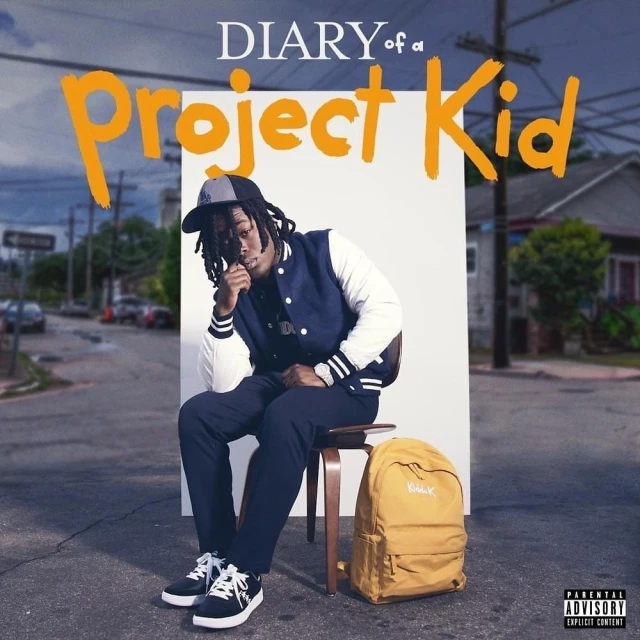 Portrait of a young adult seated on a stool with a backpack, against a backdrop of a street and album cover art.