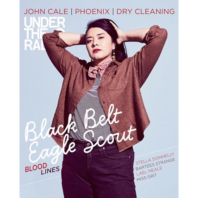 Magazine cover featuring a person in a brown shirt and jeans, with hands behind their head, with the text 'Black Belt Eagle Scout'.