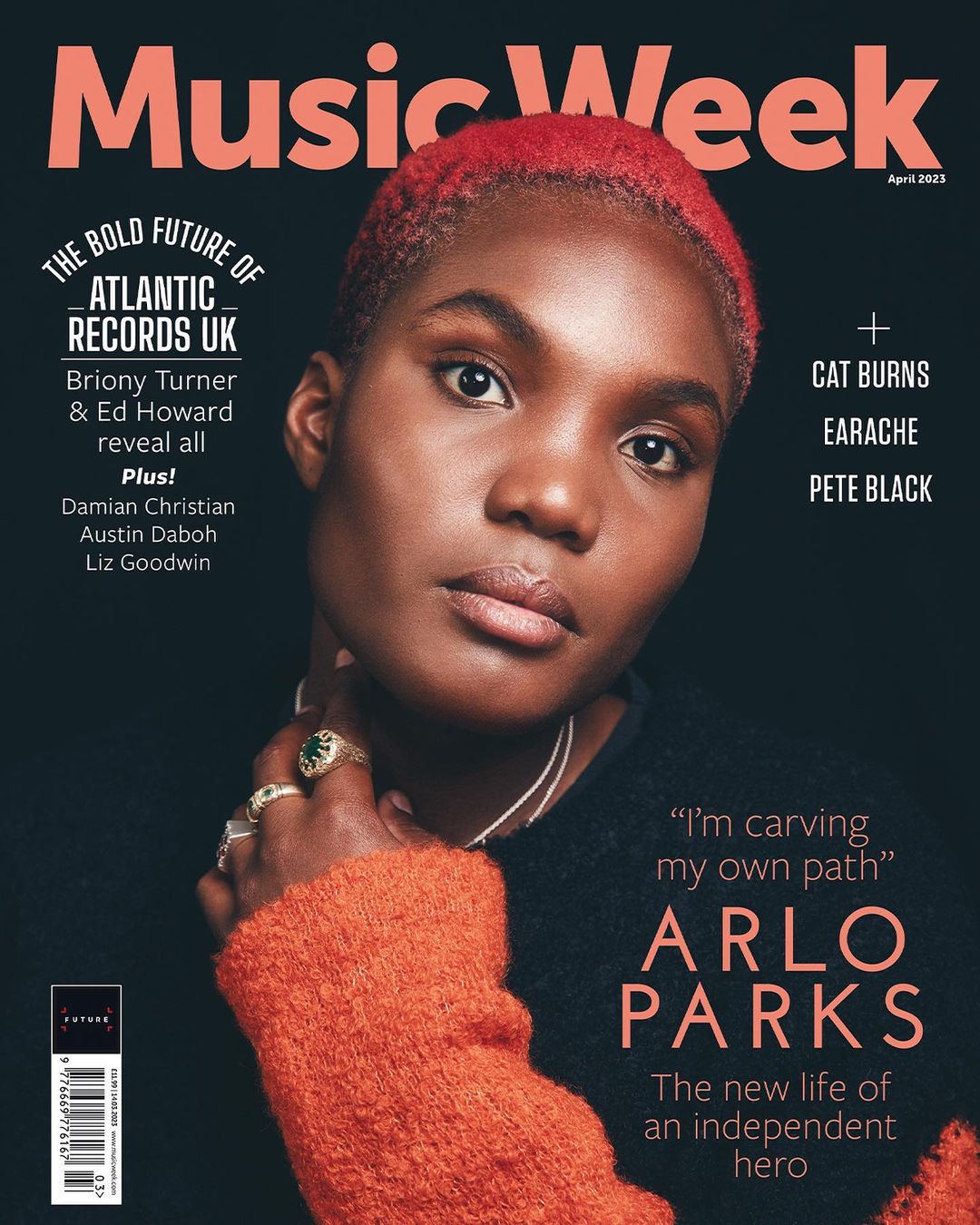 Music Week magazine cover featuring Arlo Parks. Close-up of Arlo Parks with coral hair wearing an orange sweater and jewelry against a dark background.