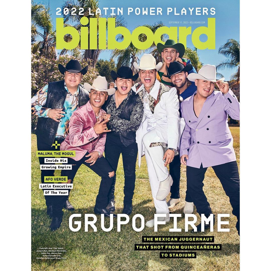 Billboard magazine cover featuring Grupo Firme. The group of seven is dressed in Western wear and hats, posed outdoors with Billboard logo.