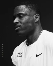 Monochrome close-up portrait of a sweating black man in a white t-shirt captured in profile by Koury Angelo