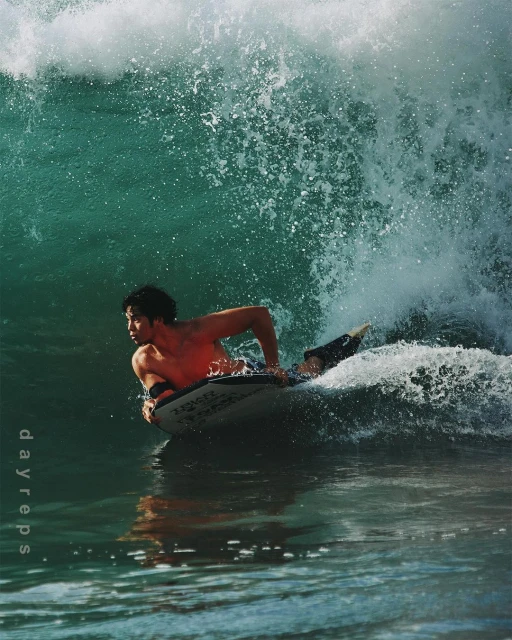 Male bodyboarder riding a wave in the ocean, showcasing the sport of bodyboarding and ocean wave activity.