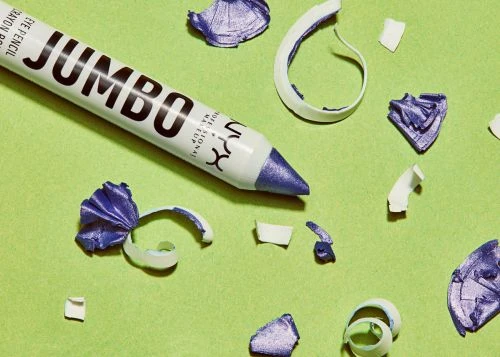 NYX Jumbo eye pencil with shavings on a lime green background in a close-up studio shot showcasing makeup product details.
