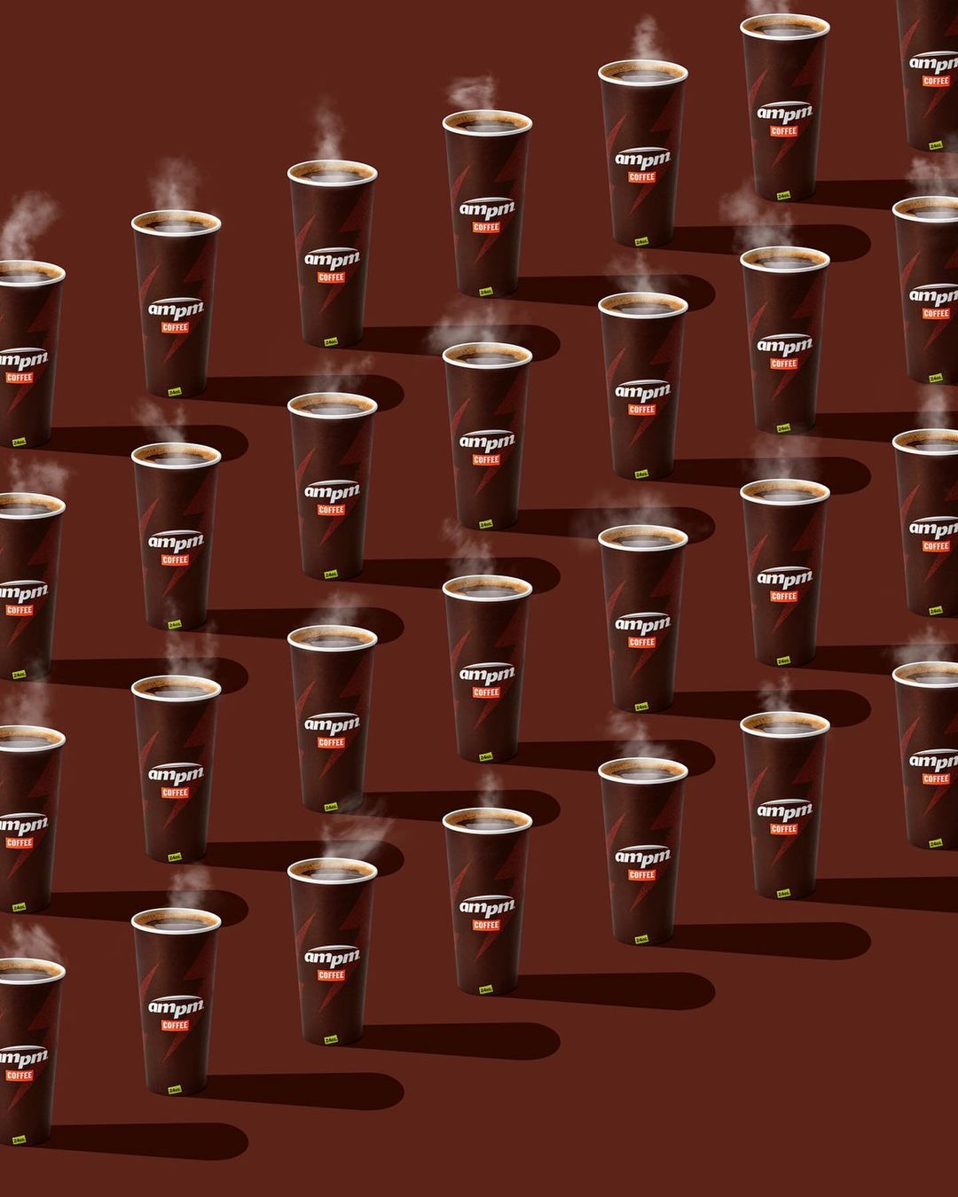 Pattern of steaming hot ampm coffee cups on a reddish-brown backdrop, arranged in rows, creating a simple yet appealing design.