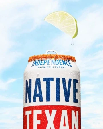 Refreshing beer can with a slice of lime against a cloudy sky, ideal for summer refreshment and beverage promotions.