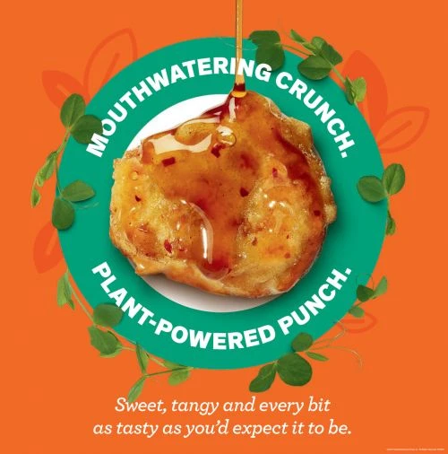 Close-up of a golden-brown, crunchy food item drizzled with syrup on a white plate with a green and orange abstract background.