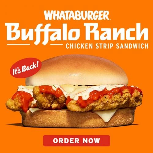 Close-up of a Whataburger Buffalo Ranch Chicken Strip Sandwich on a bun with orange sauce and white drizzle, against an orange backdrop.