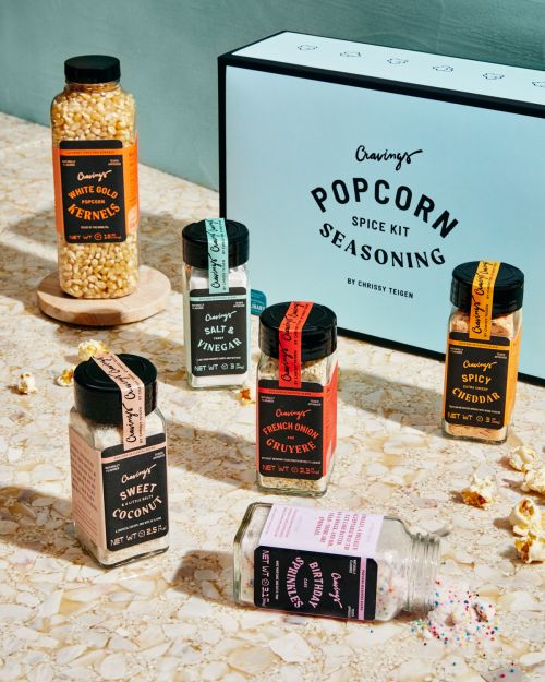 Popcorn seasoning spice kit featuring various flavors of popcorn seasonings, including white gold kernels, sweet coconut, and spicy cheddar.