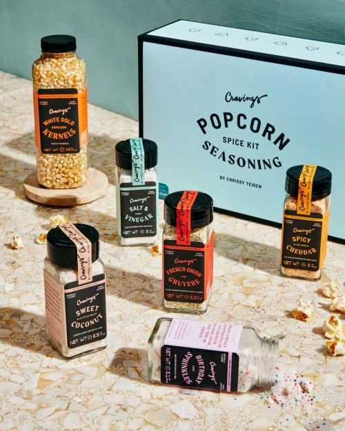 Popcorn seasoning spice kit featuring various flavors of popcorn seasonings, including white gold kernels, sweet coconut, and spicy cheddar.
