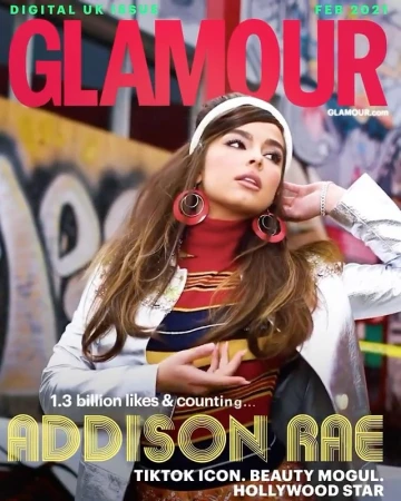 Glamour magazine cover featuring Addison Rae, a young woman with long brown hair, wearing a retro outfit against a graffiti background.